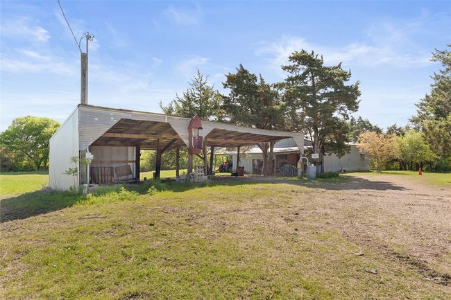 Workshop is one car garage space with Apartment.40' Pole barn provides four car covered parking. | Image 26