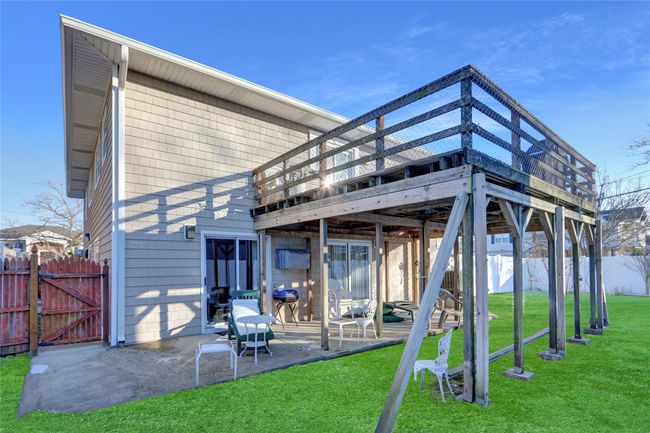 Rear view of property with a yard, a patio, and a deck | Image 5