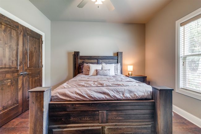 Bedroom with ceiling fan and dark wood-type flooring | Image 15