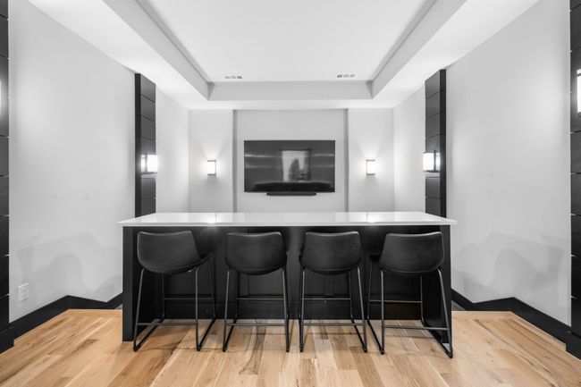 Cinema with light wood-type flooring, a raised ceiling, and a dry bar | Image 28