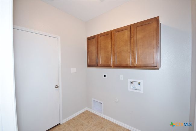 Utility room with cabinets | Image 33