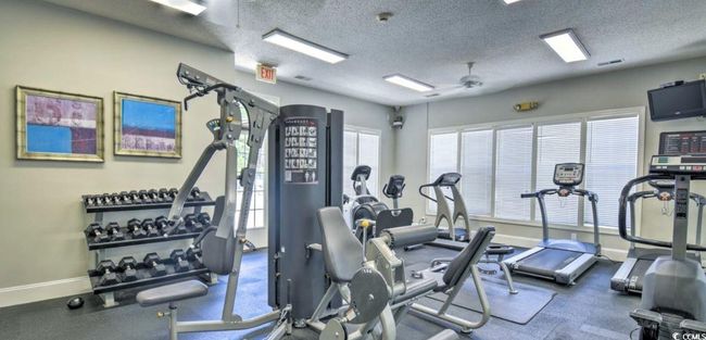 Exercise room with ceiling fan and a textured ceiling | Image 27