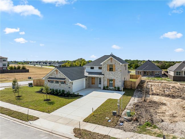 View of front of property featuring a front yard and a garage | Image 46