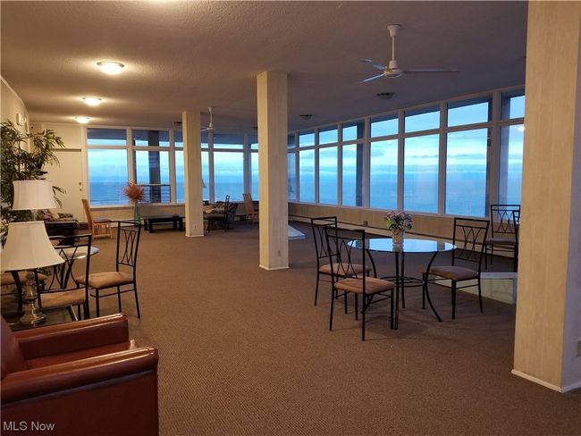 Dining room with ceiling fan, carpet, a water view, and a textured ceiling | Image 29