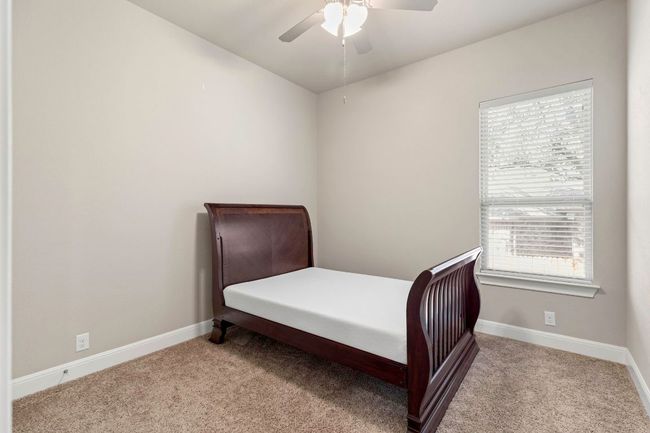 Carpeted bedroom with baseboards and a ceiling fan | Image 17