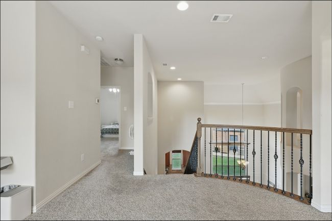 Stairs featuring arched walkways, a ceiling fan, a textured wall, and a high ceiling | Image 26