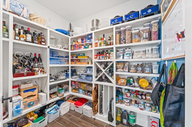 Incredible walk-in pantry with floor-to-ceiling custom shelving, wine and spice storage, and room for every kitchen essential. | Image 10