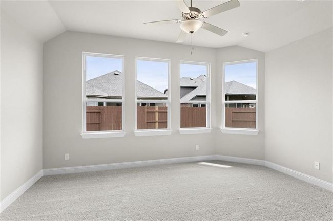 Empty room with lofted ceiling, carpet flooring, plenty of natural light, and ceiling fan | Image 13
