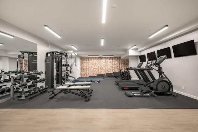 Exercise room with wood finished floors | Image 15