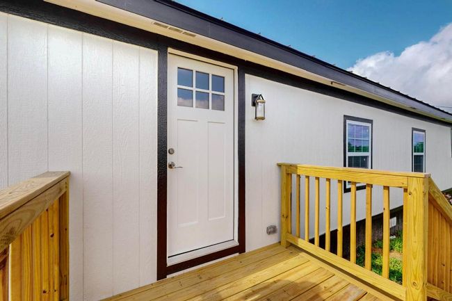 View of exterior entry with a wooden deck | Image 4