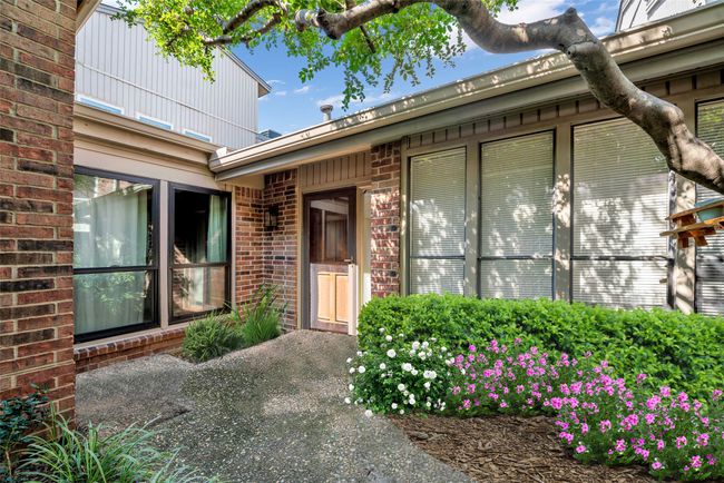 Private front patio space with sprinklers in all garden beds. | Image 4