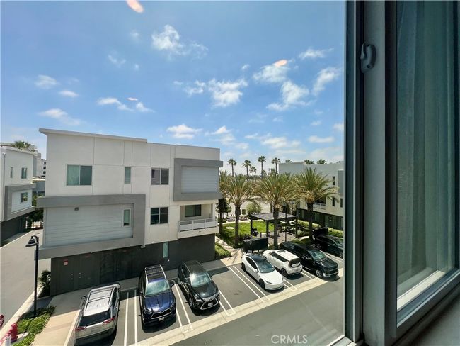 View from the primary bedroom. Guest parking just across the unit and view of the garden/BBQ area. | Image 19