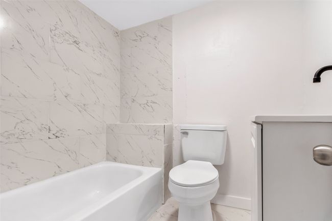 Full bathroom with marble finish floors and vanity | Image 36