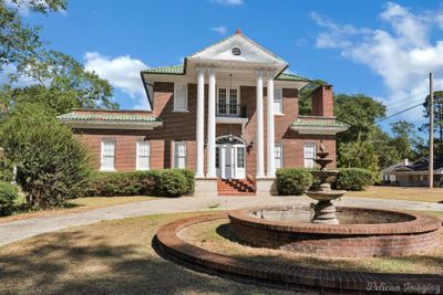 Neoclassical / greek revival house with french doors and a balcony | Image 1