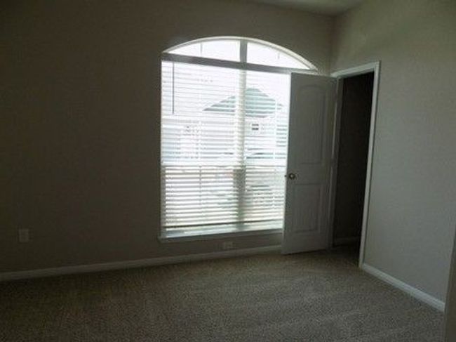 Carpeted spare room with healthy amount of natural light and baseboards | Image 11