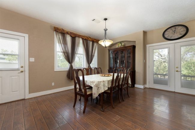 Dining area featuring plenty of natural light, baseboards, french doors, and dark wood-style flooring | Image 11