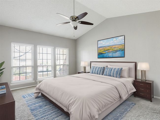 Bedroom featuring multiple windows, baseboards, lofted ceiling, and carpet | Image 14