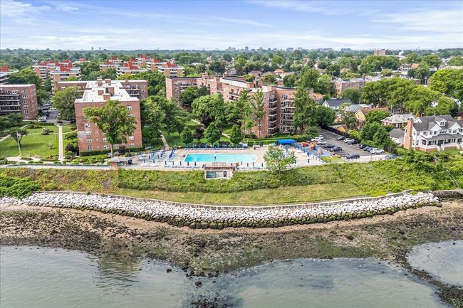 Aerial view of a pool area and a large body of water | Image 20