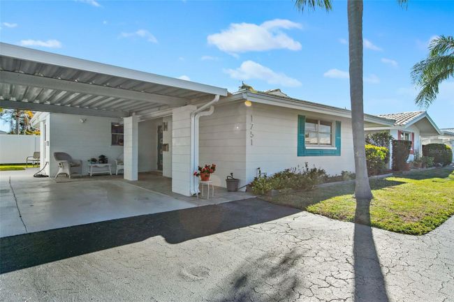 Your villa has a covered carport. | Image 1