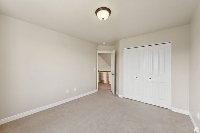 Unfurnished bedroom with light colored carpet and a closet | Image 21
