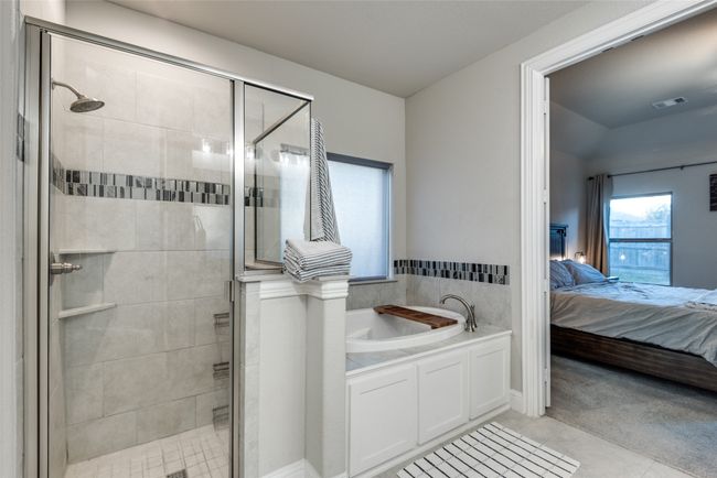 Ensuite bathroom featuring a shower stall, ensuite bathroom, a bath, tile patterned flooring, and visible vents | Image 18