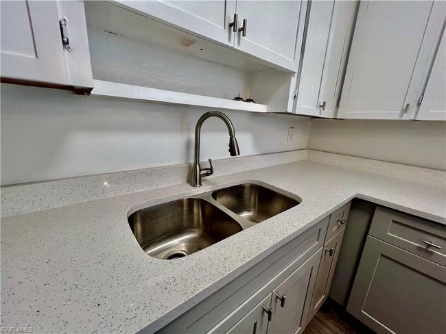 Kitchen featuring open shelves, a sink, white cabinetry, and light QUARTZ counters | Image 12