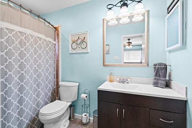 Bathroom featuring baseboards, toilet and vanity | Image 14