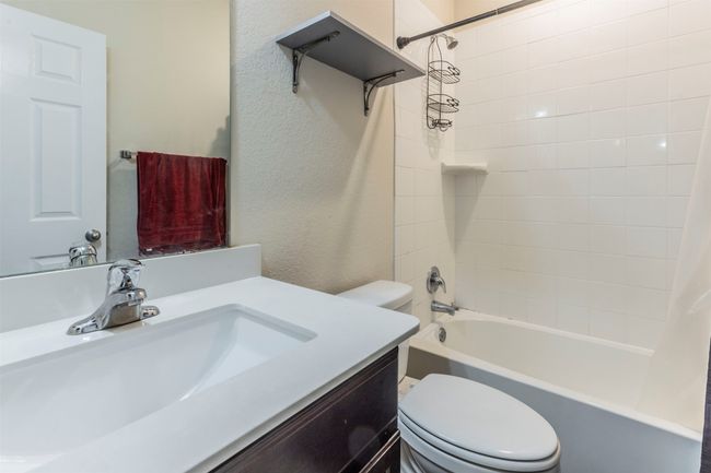 Bathroom featuring vanity, toilet, and shower / tub combo with curtain | Image 19