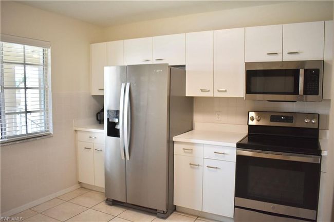 Kitchen with room for a table at the window with partial view of the lake | Image 4
