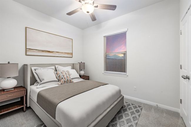 Carpeted bedroom with a ceiling fan and baseboards | Image 17