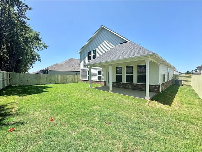 Large covered patio area to relax on overlooking the fenced in backyard. | Image 22