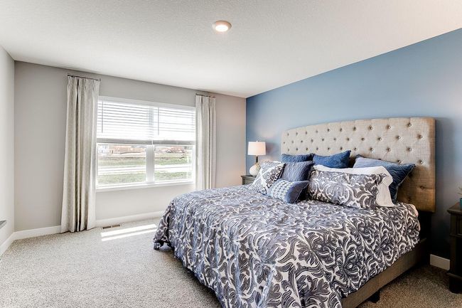 An oasis on it's own, the home's primary suite is awesome and loaded - including immediate access to a private bath that is equally appointed with features and is home to an oversized walk-in closet! Photo of model home, color & options may vary. | Image 15