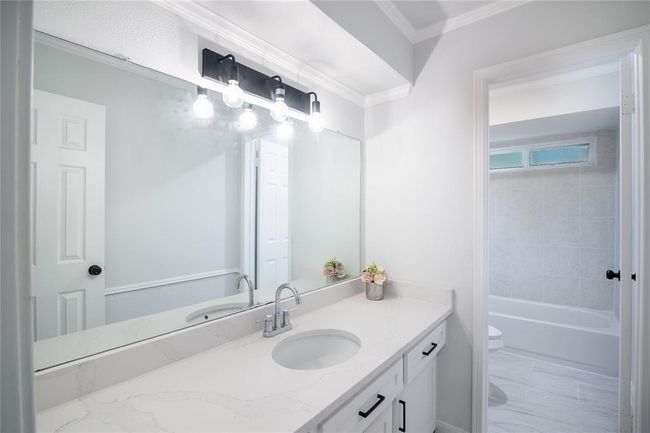 This beautiful full secondary bathroom with much storage under the sink, with a delightful separate shower/tub and toilet. | Image 30