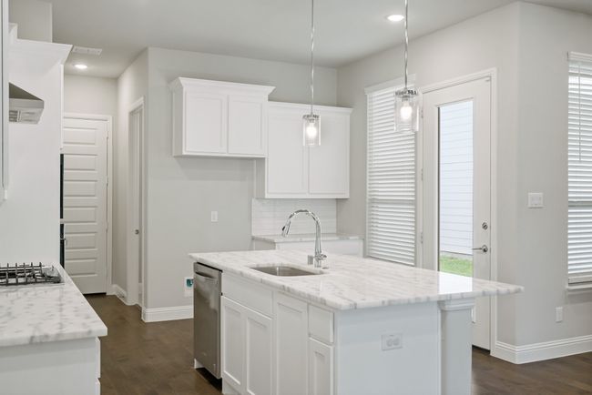Kitchen with white cabinetry, a sink, appliances with stainless steel finishes, and dark wood-type flooring | Image 14