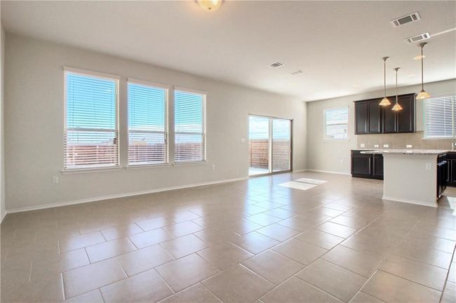 Unfurnished living room with light tile patterned flooring and baseboards | Image 13