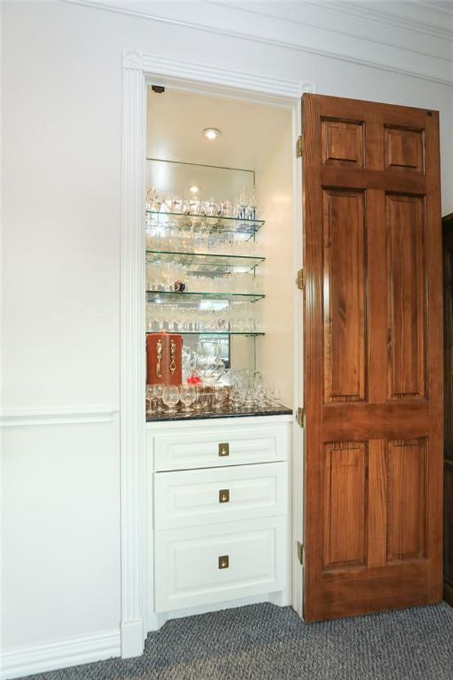 Dry bar with plenty of space to display glassware and drawers for accessories. | Image 26