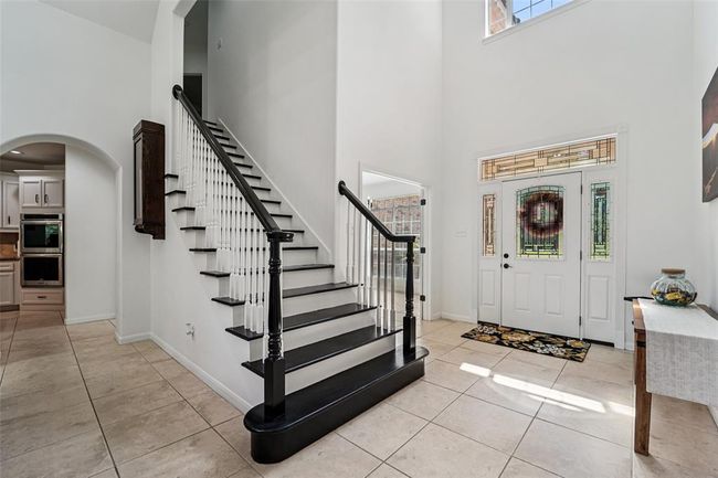 Soaring 22-foot ceilings greet you in the entry and living room. | Image 6