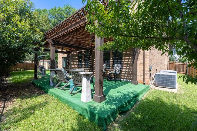 View of yard featuring central air condition unit, ceiling fan, and a pergola | Image 35