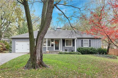 Ranch-style home with a front yard and a garage | Image 1