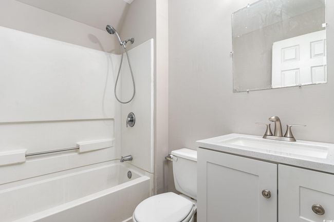 Bathroom with vanity, toilet, and bathing tub / shower combination | Image 21