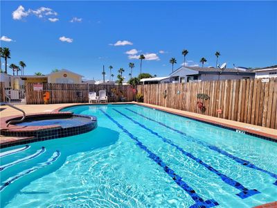 View of swimming pool with a community hot tub | Image 3