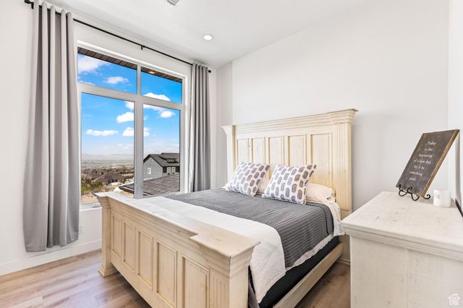 Bedroom featuring multiple windows, baseboards, light wood finished floors, and recessed lighting | Image 48