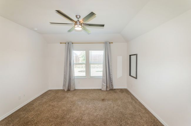 Unfurnished room with vaulted ceiling, a ceiling fan, light carpet, and baseboards | Image 16