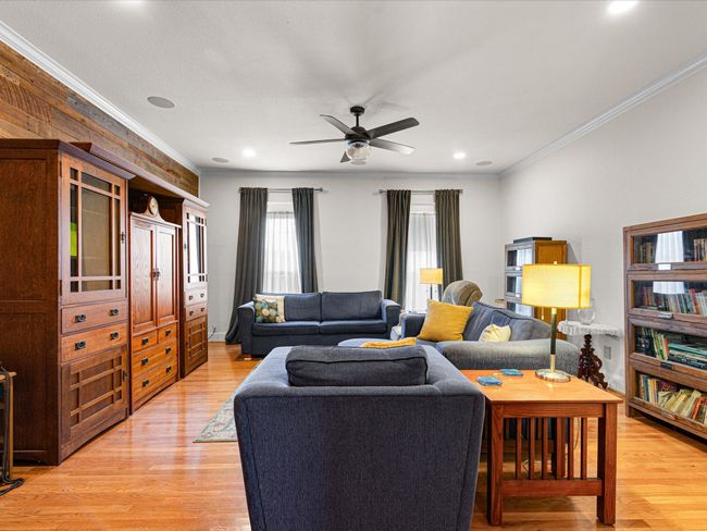 Living room with recessed lighting, light wood-style floors, ornamental molding, and a ceiling fan | Image 21