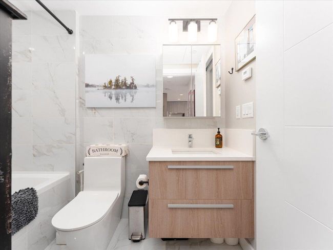 Bathroom with vanity, toilet, and tub / shower combination | Image 19
