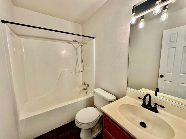 Full bathroom with shower combination, wood finished floors, and vanity | Image 16