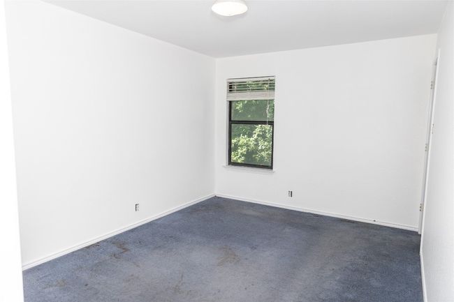 Empty room with dark colored carpet and baseboards | Image 15
