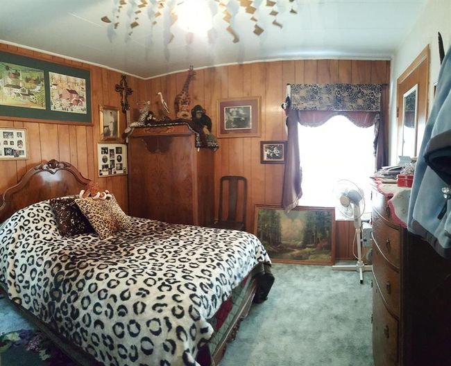 Carpeted bedroom with wood walls | Image 30
