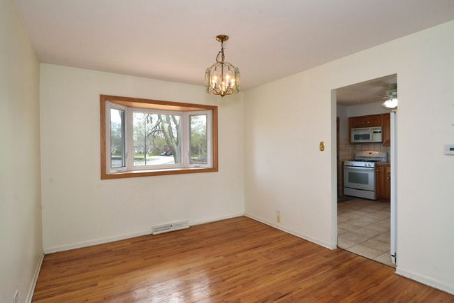 Dining room with chandelier, new thermostat, and b | Image 8