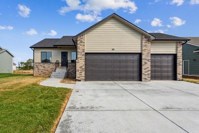 View of front of property featuring a front yard and a garage | Image 1